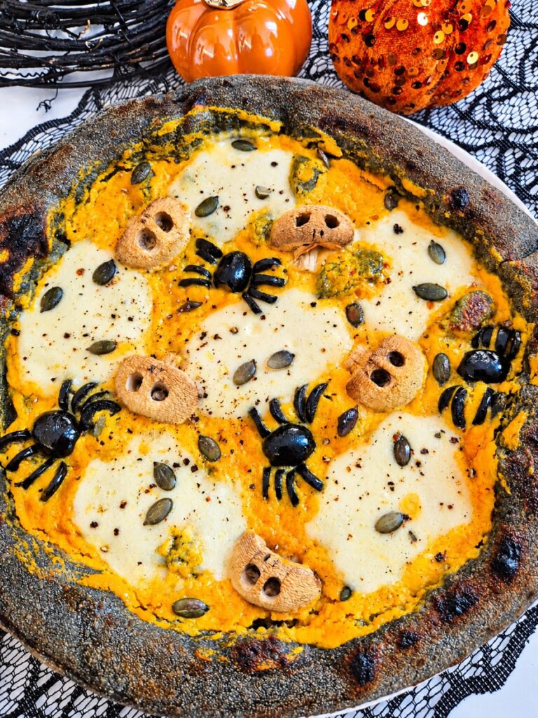 Halloween Black Pizza with Pumpkin Puree, Skulls, and Olive Spiders